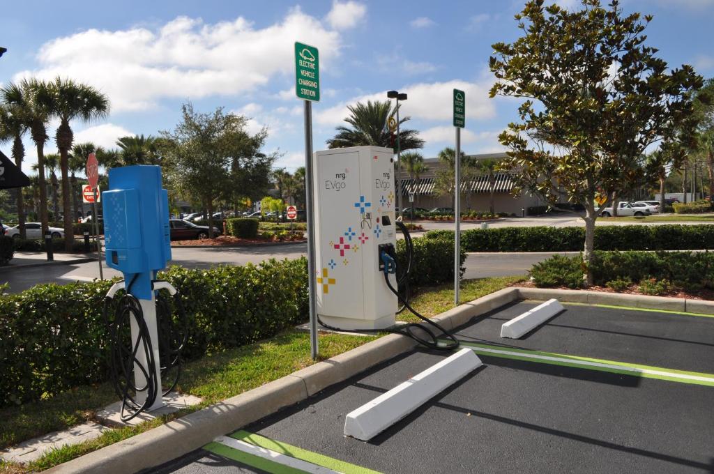 a parking lot with an electric machine in the street at Lake Buena Vista Resort Village and Spa, Near Disney in Orlando