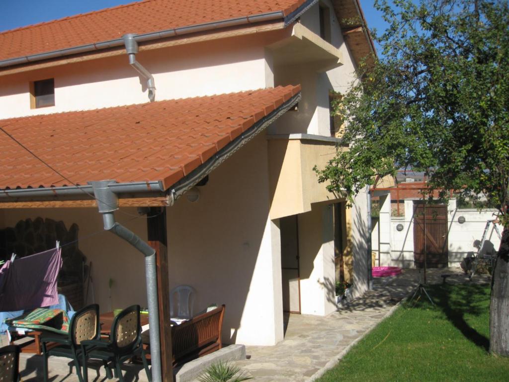 a house with an orange roof and a table and chairs at Villa Tunley in Razvalini Balchikioy