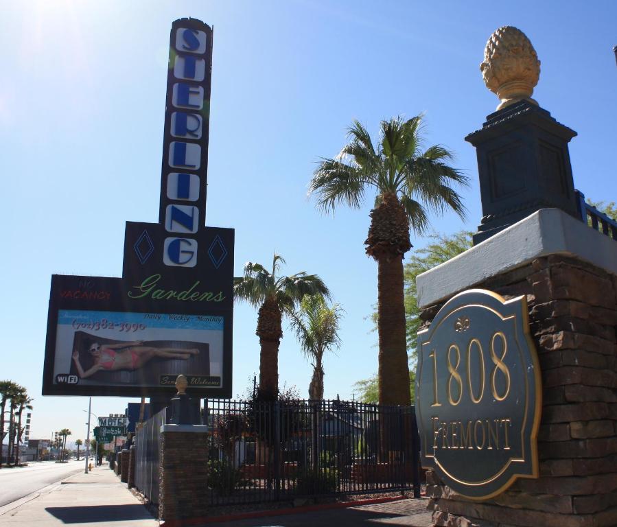 a sign for a hotel with palm trees in the background at Sterling Gardens in Las Vegas