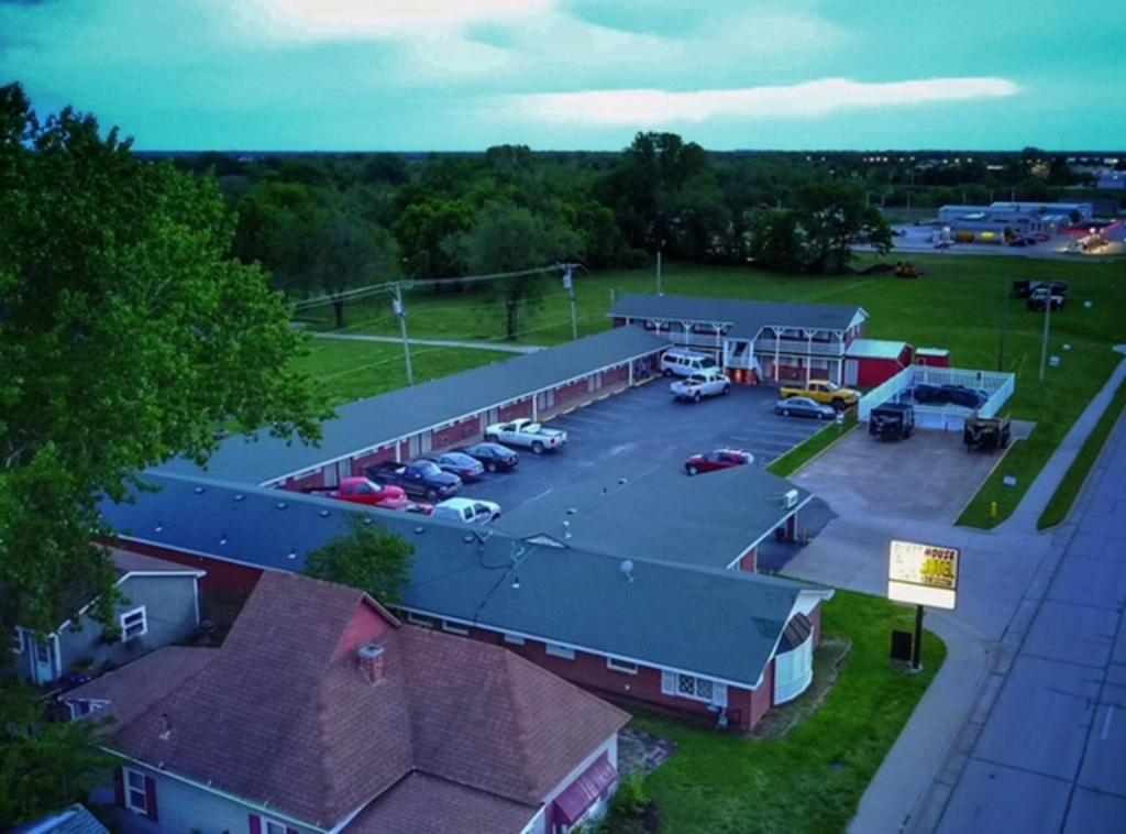 an aerial view of a building with a parking lot at Guest House Motel Chanute in Chanute