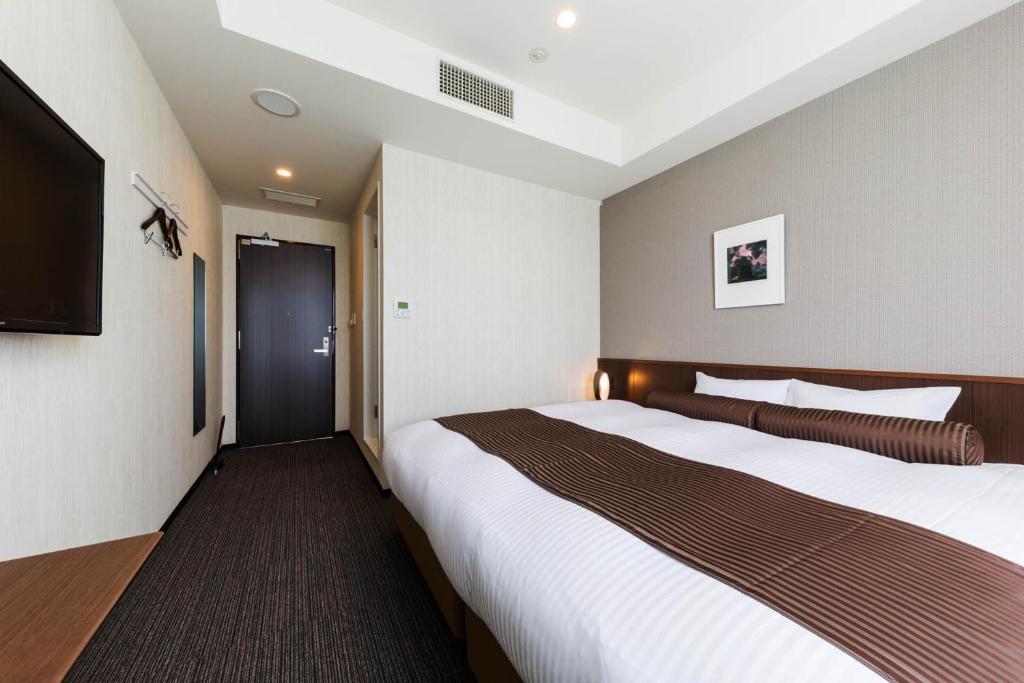 Postel nebo postele na pokoji v ubytování N Gate Hotel Osaka