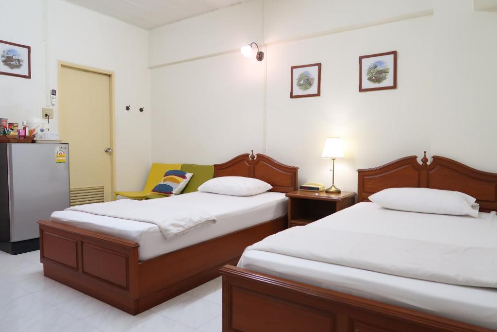 Postel nebo postele na pokoji v ubytování Phawana Sweet Hotel