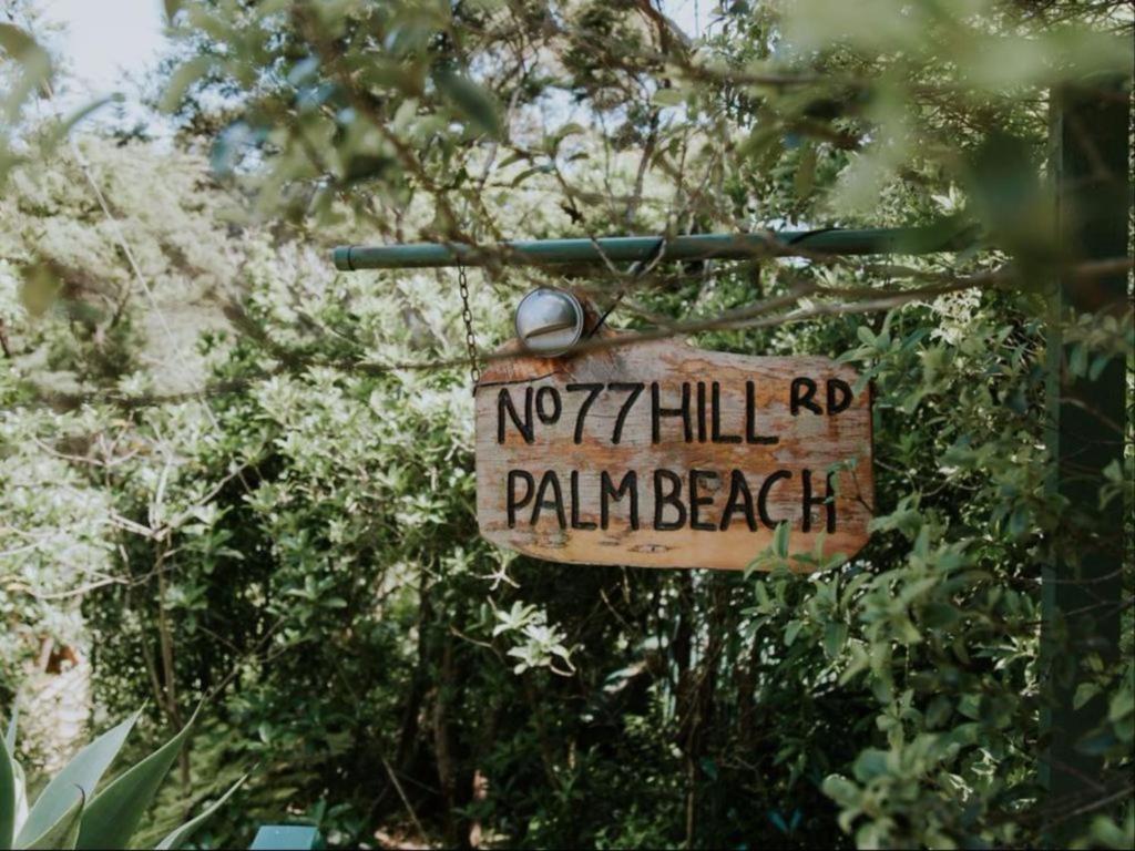 a sign that reads no hill rp palawan beach at Palm Beach Bungalows in Palm Beach