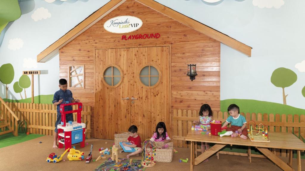 a group of children sitting in front of a play house at Hotel Indonesia Kempinski Jakarta in Jakarta