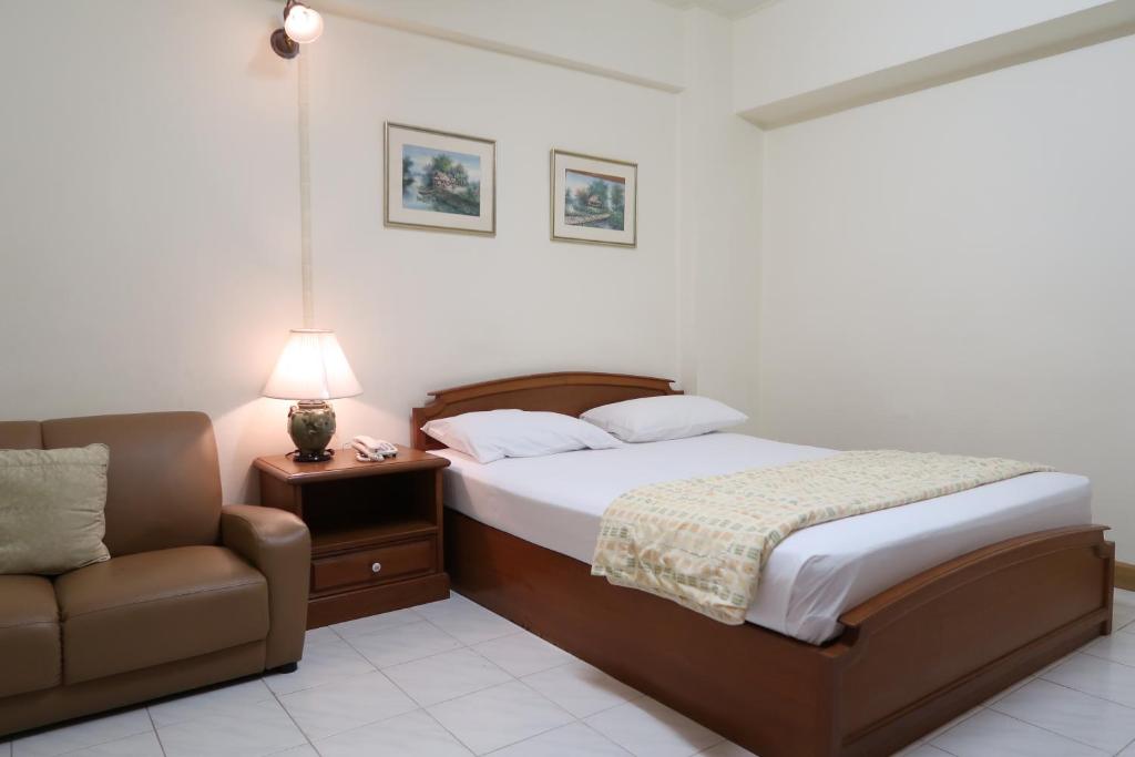 Postel nebo postele na pokoji v ubytování Phawana Sweet Hotel