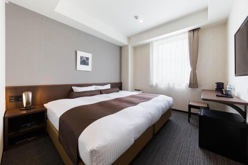 Postel nebo postele na pokoji v ubytování N Gate Hotel Osaka
