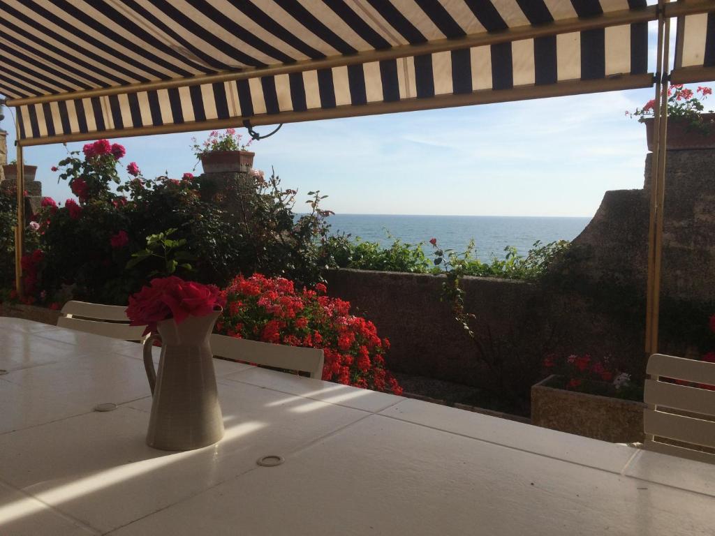 a vase sitting on a table with a view of the ocean at Anzio a picco sul mare! in Anzio