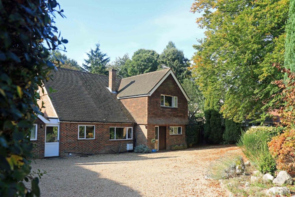 a brick house with a driveway in front of it at Dawyk Beech Guesthouse in Fleet