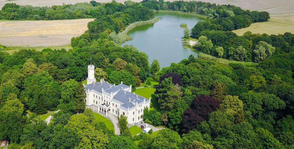 - une vue aérienne sur un château et un lac dans l'établissement Romantik Hotel Schloss Reichenow, à Reichenow