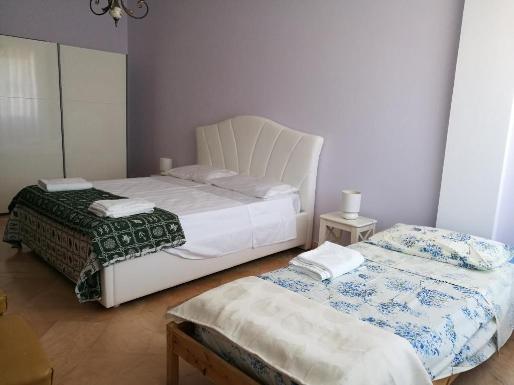 Postel nebo postele na pokoji v ubytování B&B Domus Lupiae