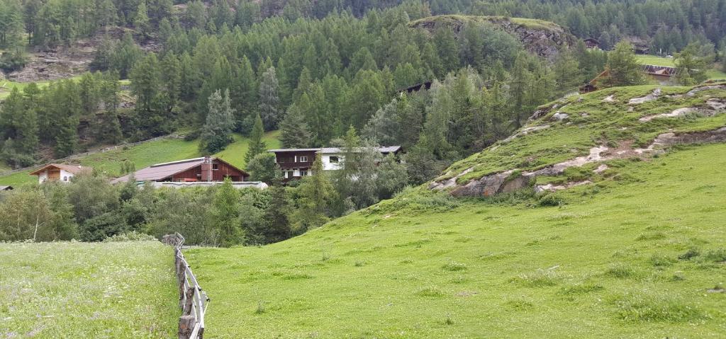 a green field with a fence on a hill at Ferienhaus Anna in Sölden