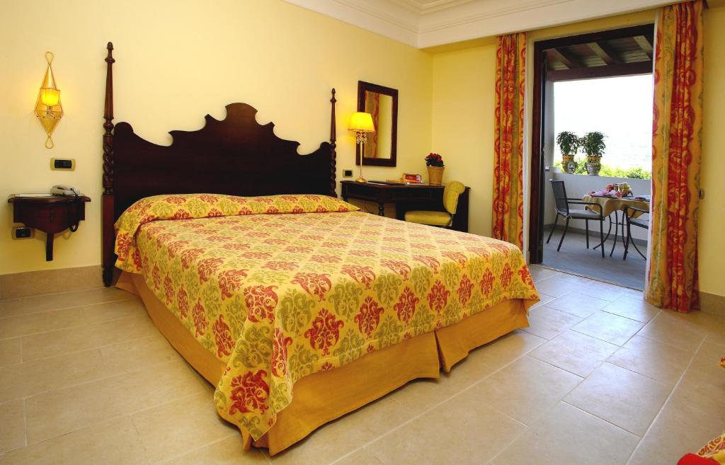 Postel nebo postele na pokoji v ubytování Arciduca Grand Hotel
