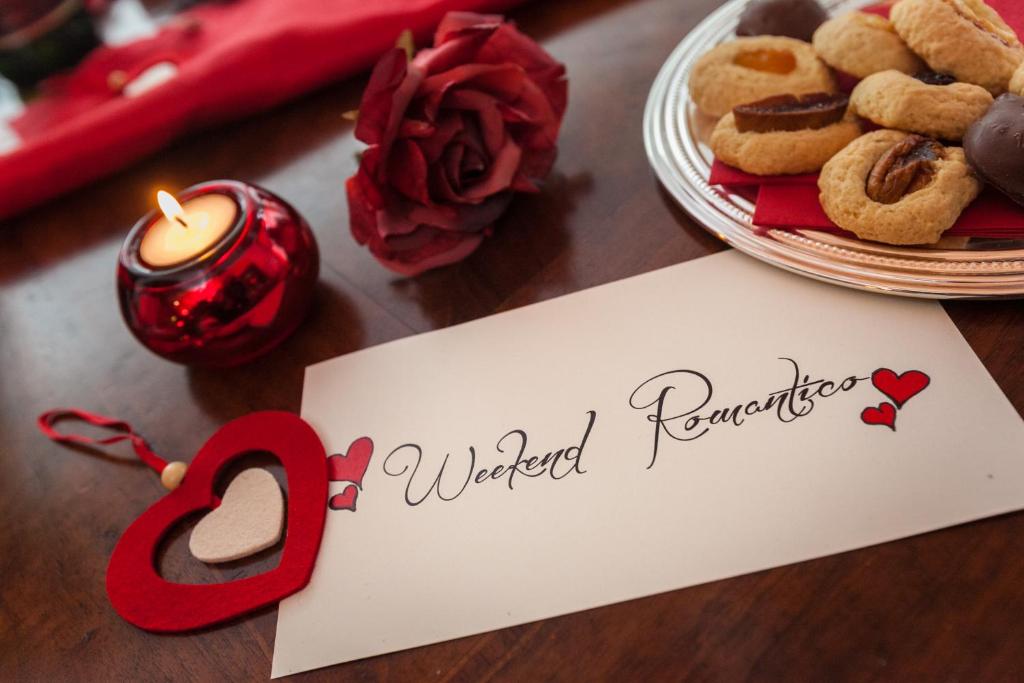 a table with a sign and a plate of cookies at B&B Villa San Leonardo in Mascali