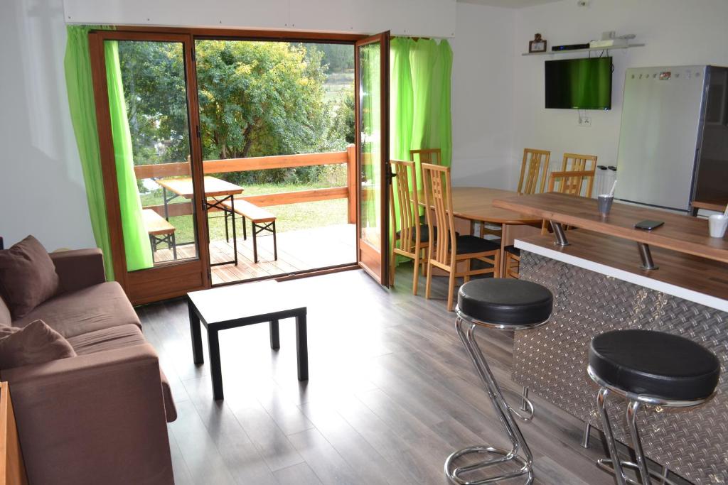 a living room with a couch and a table and chairs at Edelweiss Valberg in Valberg