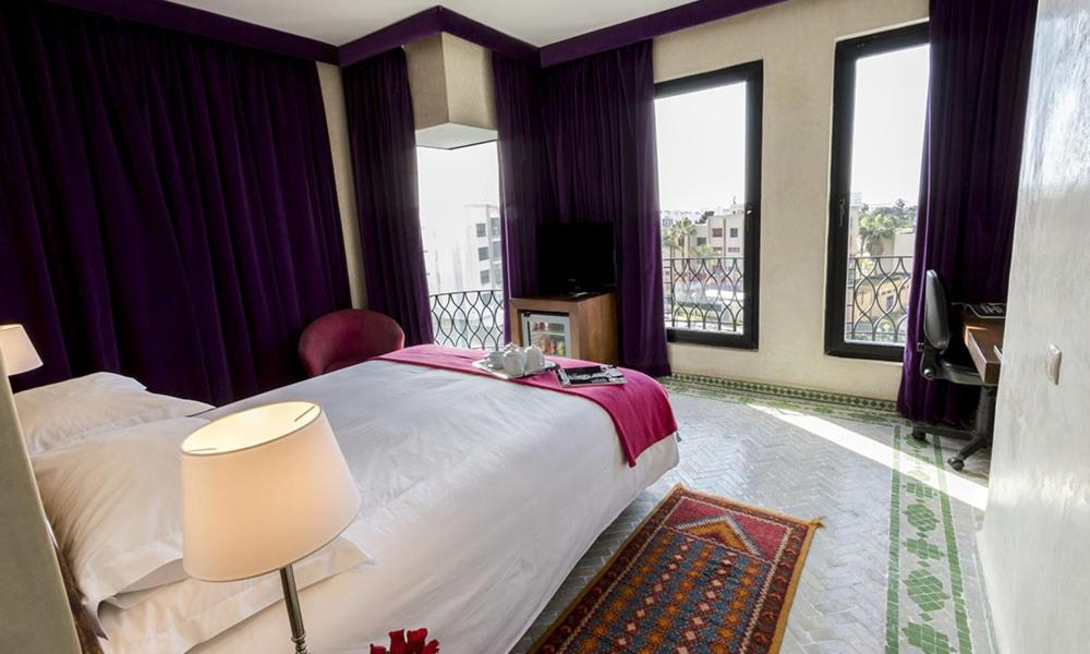 Postel nebo postele na pokoji v ubytování Soundouss Hotel