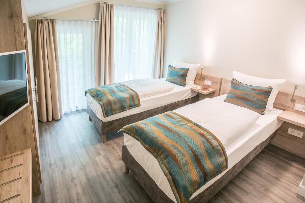 Postel nebo postele na pokoji v ubytování AKZENT Apartmenthotel Residenz
