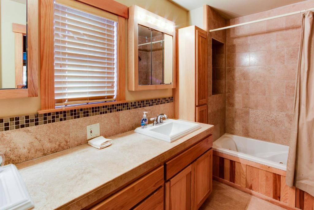 a bathroom with a sink and a toilet and a tub at Stockholm Luxury Retreat in Truckee