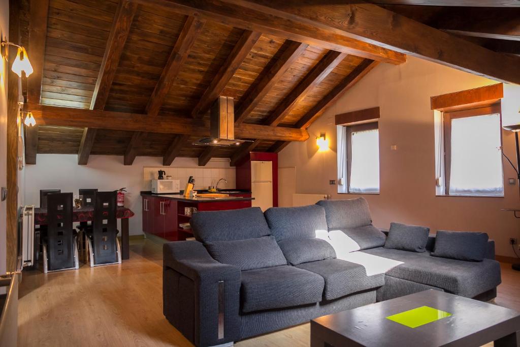 a living room with a couch and a table at Aiestaenea Apartamentos Rurales in Isaba