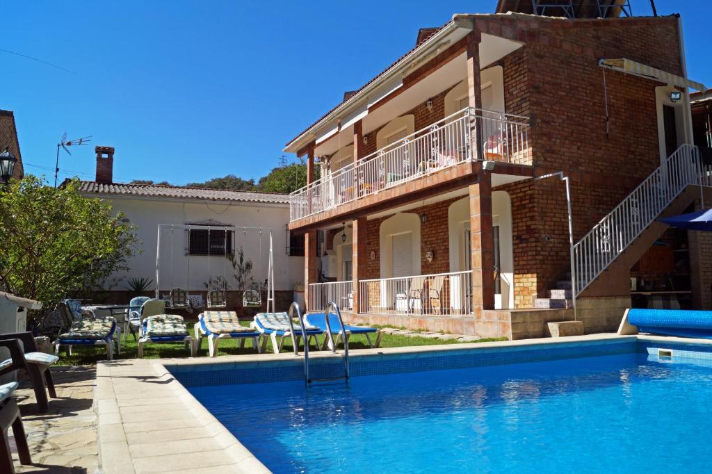 a house with a swimming pool in front of a house at Casa Rural El Nacimiento in Benaoján