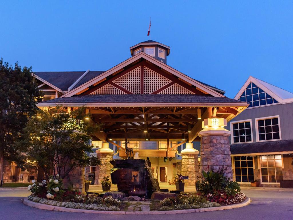 a large stone building with a clock on the front of it at Deerhurst Resort in Huntsville