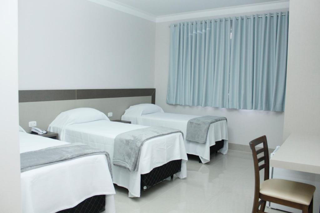 Postel nebo postele na pokoji v ubytování Hotel Cadori