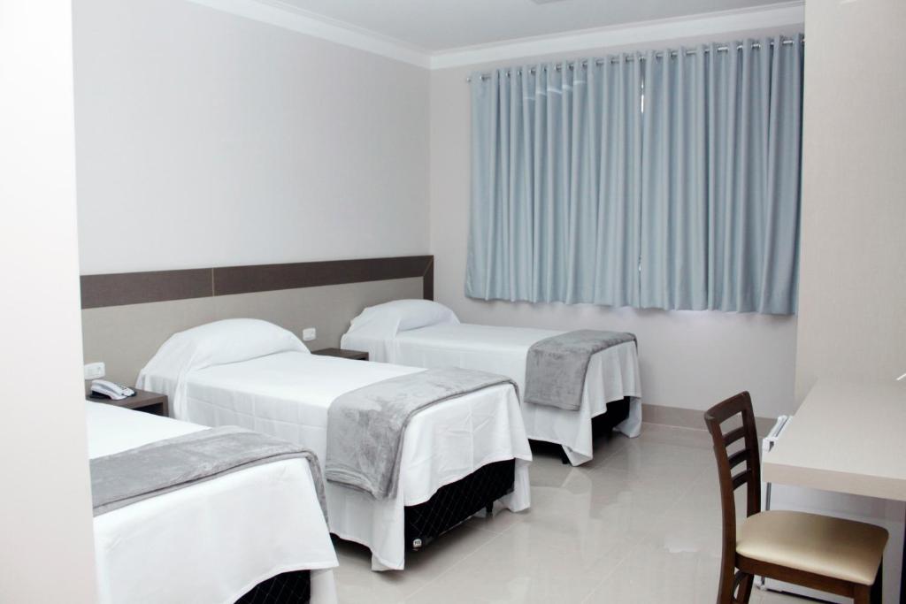 Postel nebo postele na pokoji v ubytování Hotel Cadori