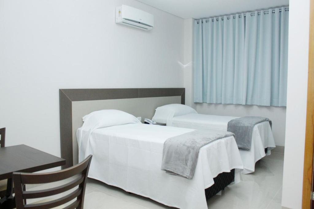 Postel nebo postele na pokoji v ubytování Hotel Cadori