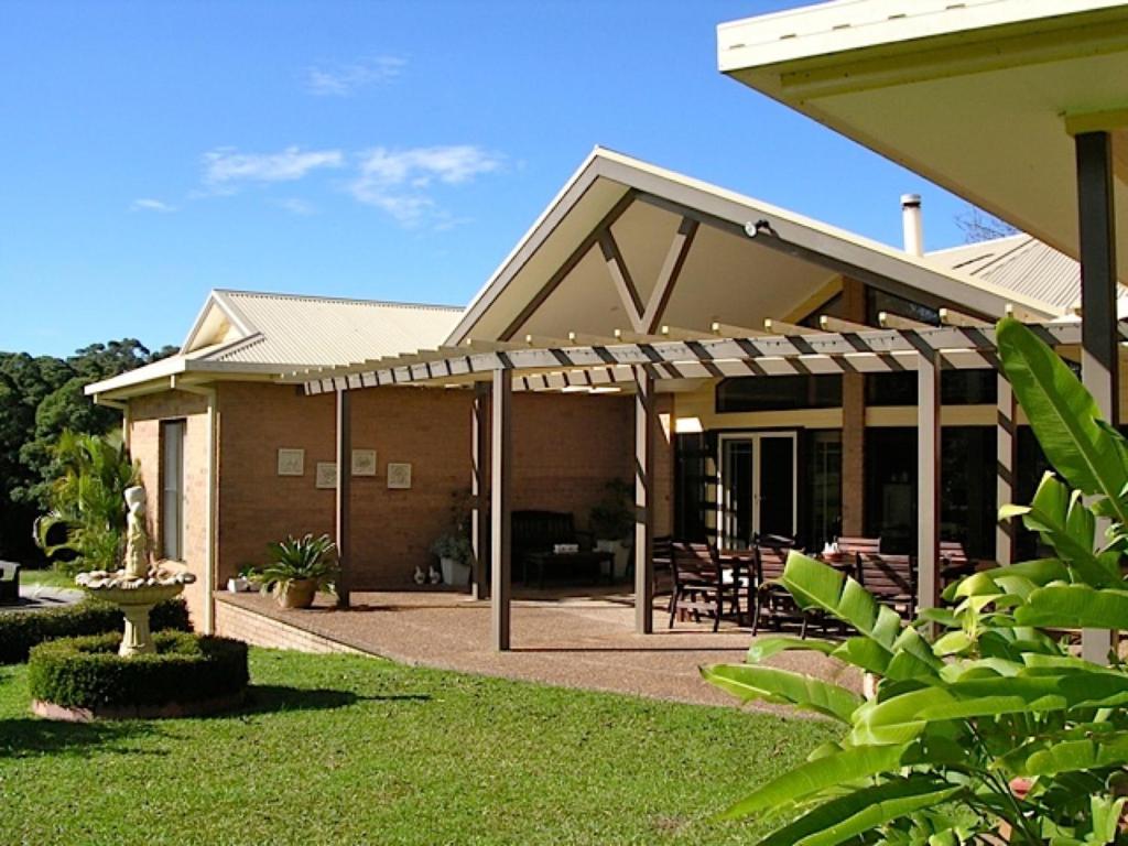 a house with awnings on the front of it at Yarrahapinni Homestead in Yarrahapinni