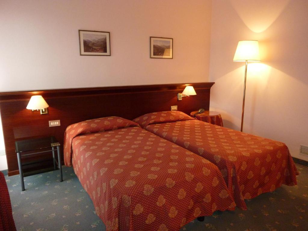 Postel nebo postele na pokoji v ubytování Hotel Torretta