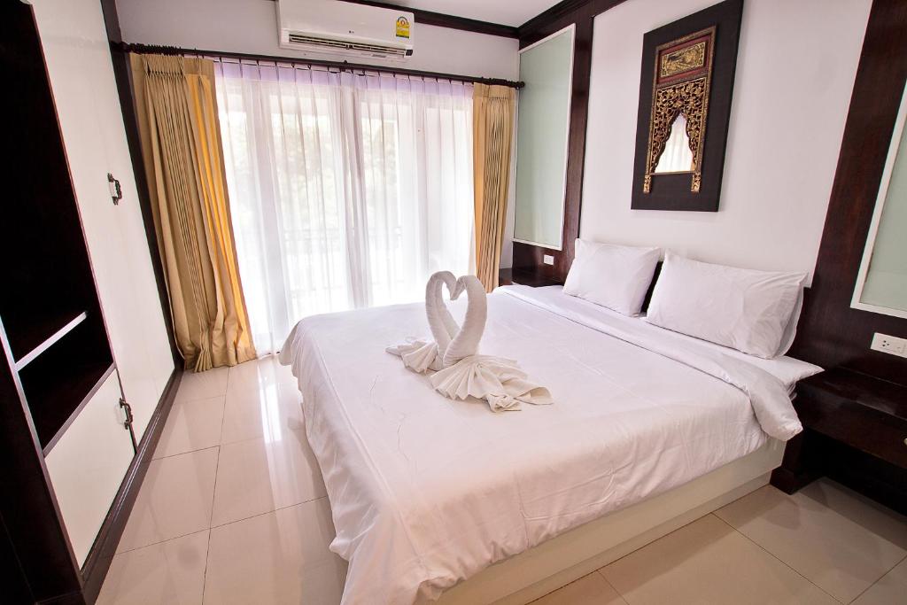 Postel nebo postele na pokoji v ubytování V Condominium Samui