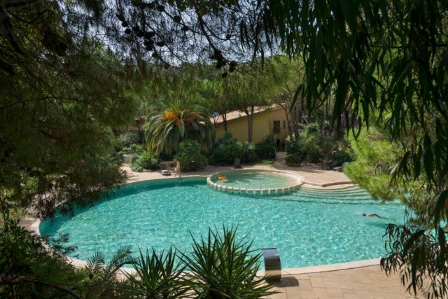una gran piscina en medio de un patio en Abbaechelu, en Santa Margherita di Pula