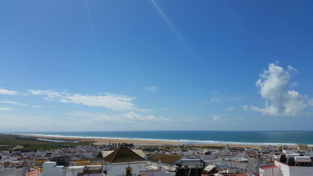 a view of a city and the beach at Apartamento Mayte in Conil de la Frontera