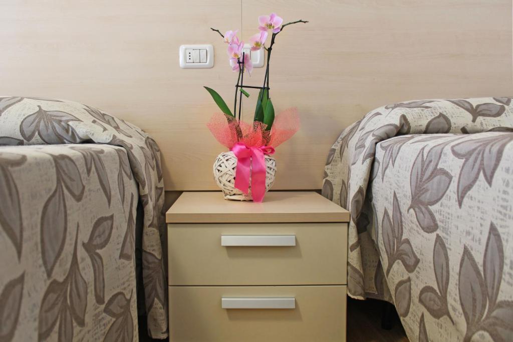 Postel nebo postele na pokoji v ubytování Hotel Silvia