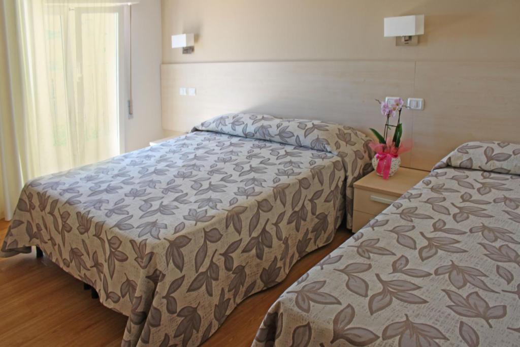Postel nebo postele na pokoji v ubytování Hotel Silvia