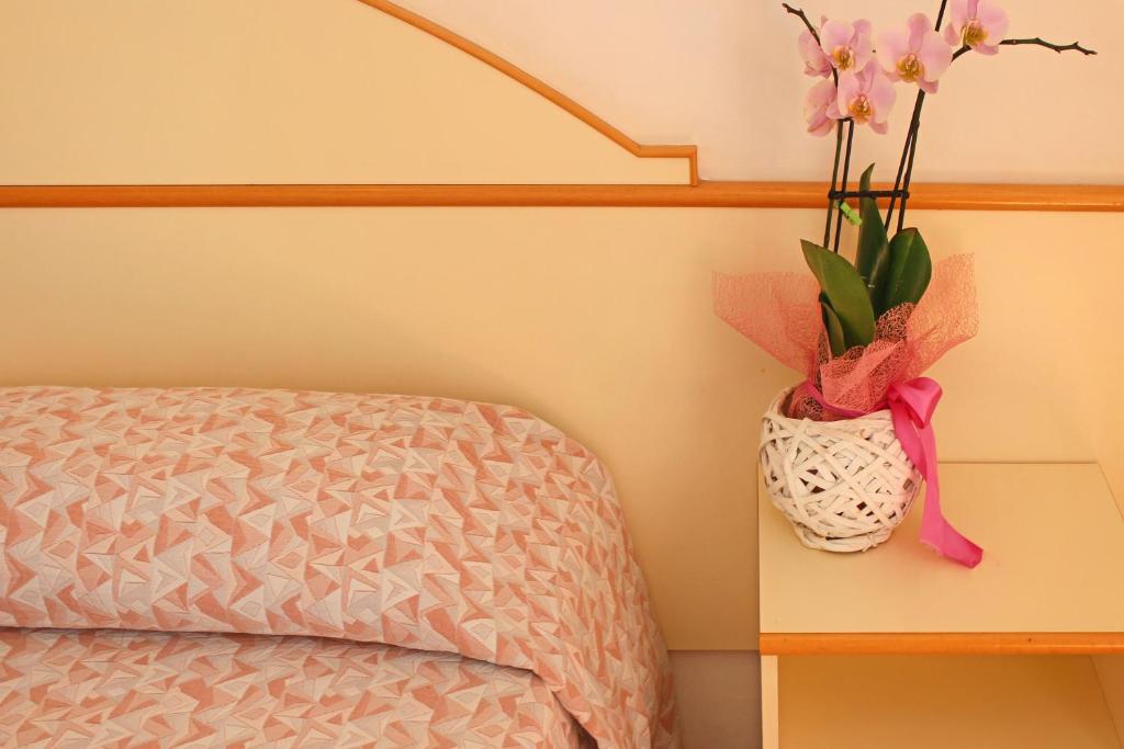 Postel nebo postele na pokoji v ubytování Hotel Silvia