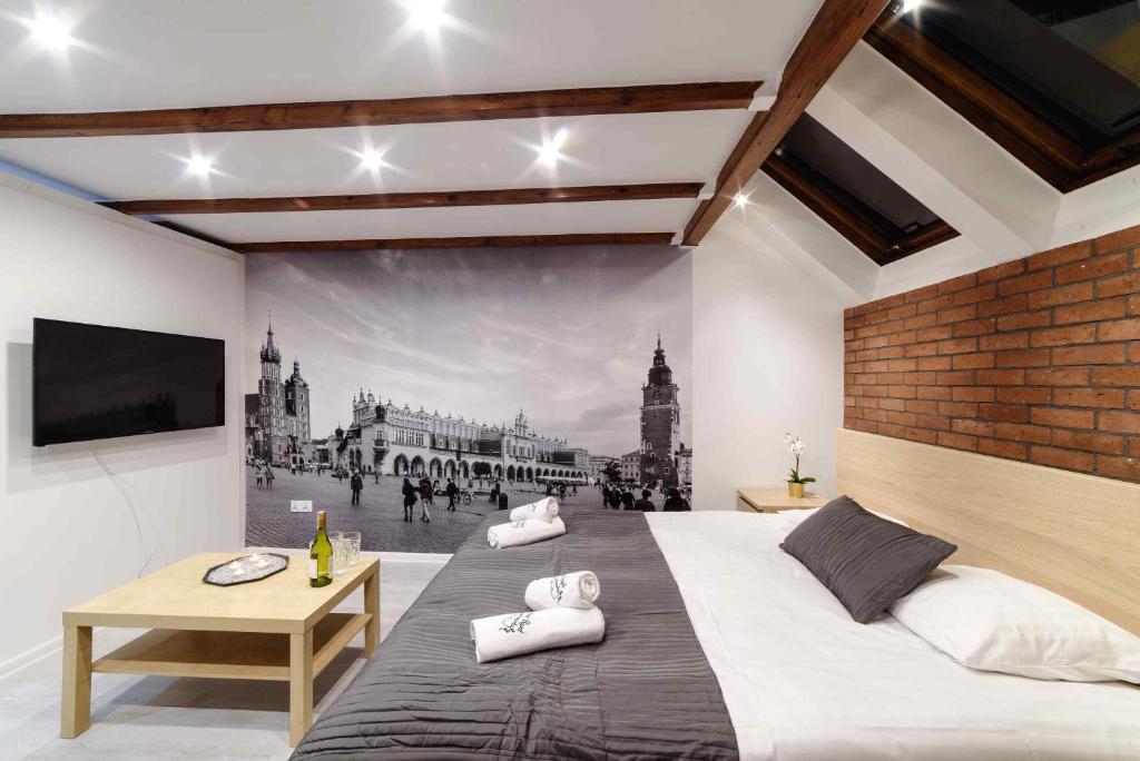 a bedroom with a large bed and a wall mural at Cracow Rent Apartments - spacious apartments for 2-7 people in quiet area - Kolberga Street nr 3 - 10 min to Main Square by foot in Krakow