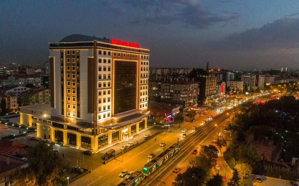 a lit up building in a city at night at Bayır Diamond Hotel & Convention Center Konya in Konya