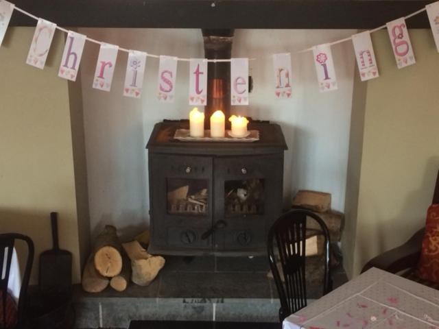 a living room with a fireplace with candles on it at Hatton's of Garadice in Garadice