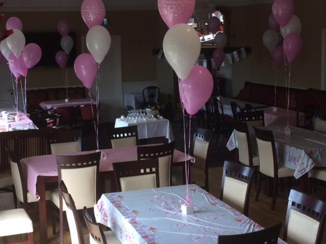a room with pink and white balloons and tables and chairs at Hatton's of Garadice in Garadice