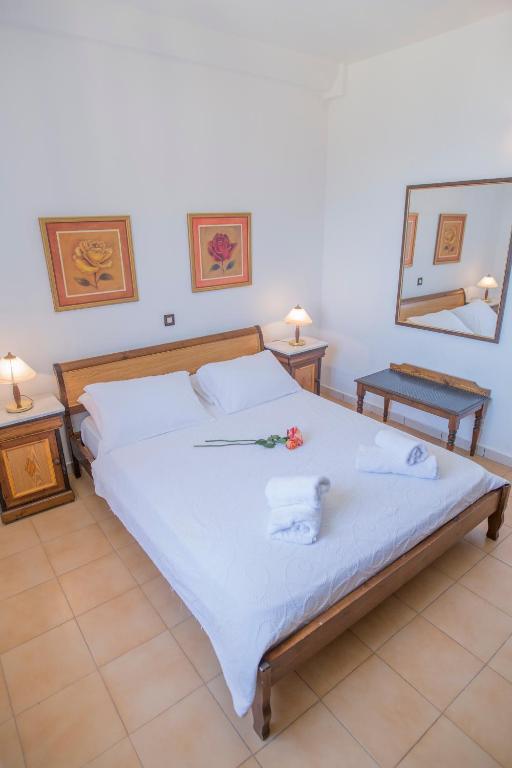 A bed or beds in a room at Corfu Aquamarine Hotel