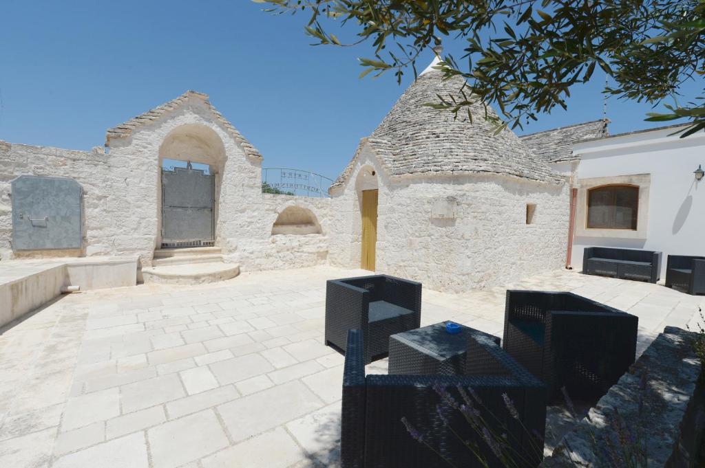 a large stone building with a window and a roof at Agriturismo L'Aire Alberobello in Alberobello