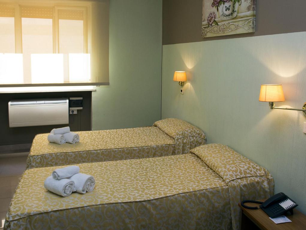 Postel nebo postele na pokoji v ubytování Hotel Plaza