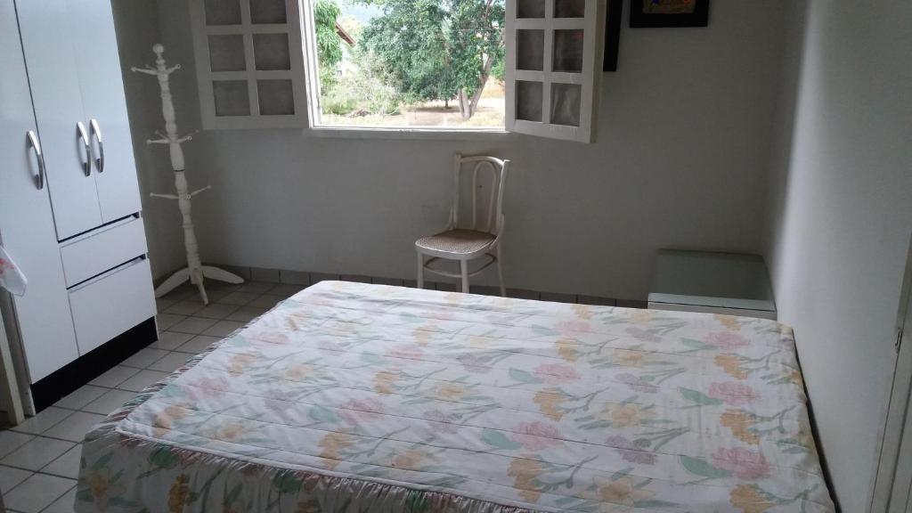 A bed or beds in a room at Casa de Campo com piscina