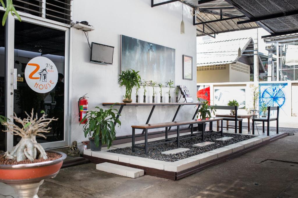 a group of benches sitting outside of a building at Zzhouse in Chiang Mai