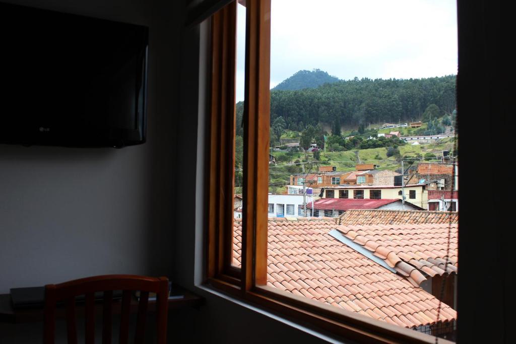a window with a view of a roof at Hotel Cacique Real in Zipaquirá