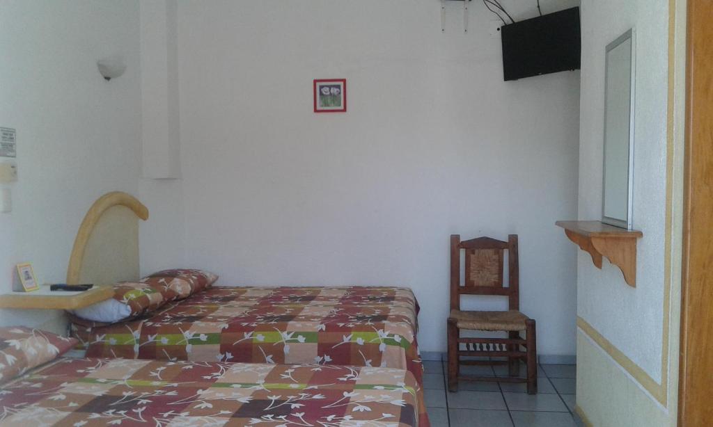 Postel nebo postele na pokoji v ubytování Hotel Sarabi