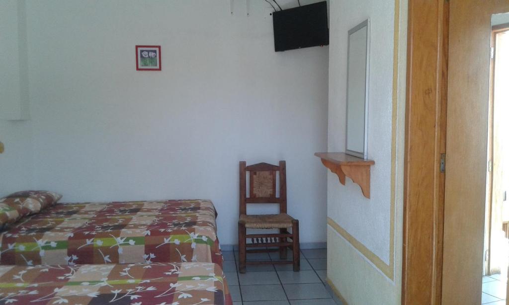 Postel nebo postele na pokoji v ubytování Hotel Sarabi