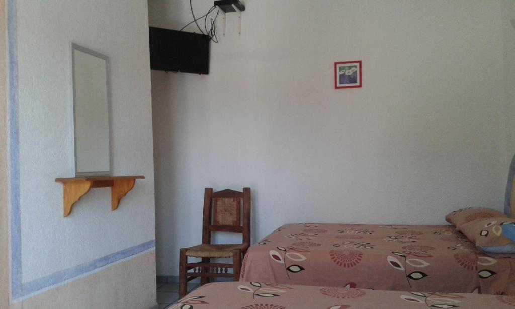 Postel nebo postele na pokoji v ubytování Hotel Sarabi