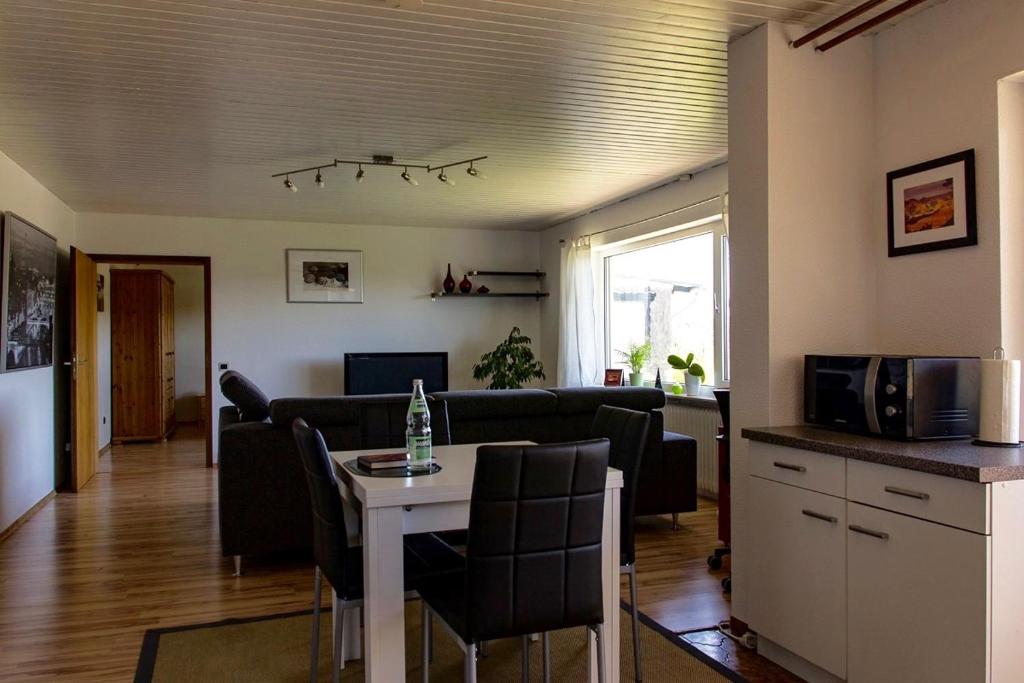 a living room with a couch and a table with chairs at Apartment Bellevue in Blieskastel