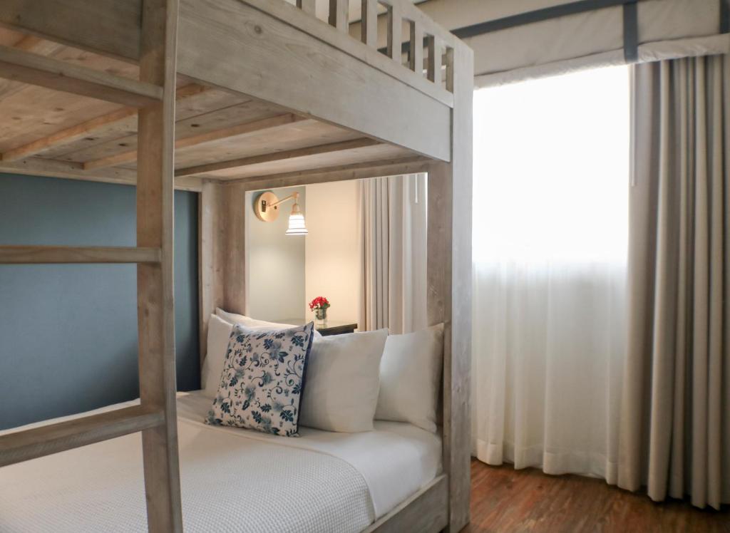 a bedroom with a loft bed with white pillows at The Milo in Santa Barbara